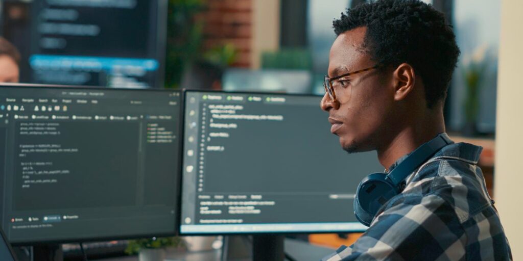 desenvolvedor de software negro olhando para monitor