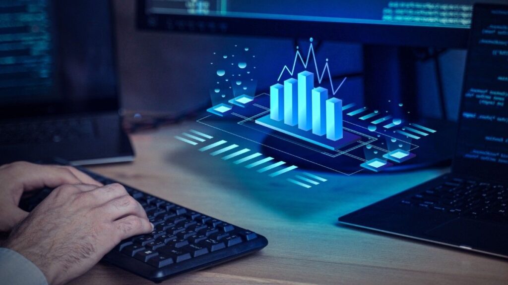 pessoa mexendo no computador com gráficos azuis 